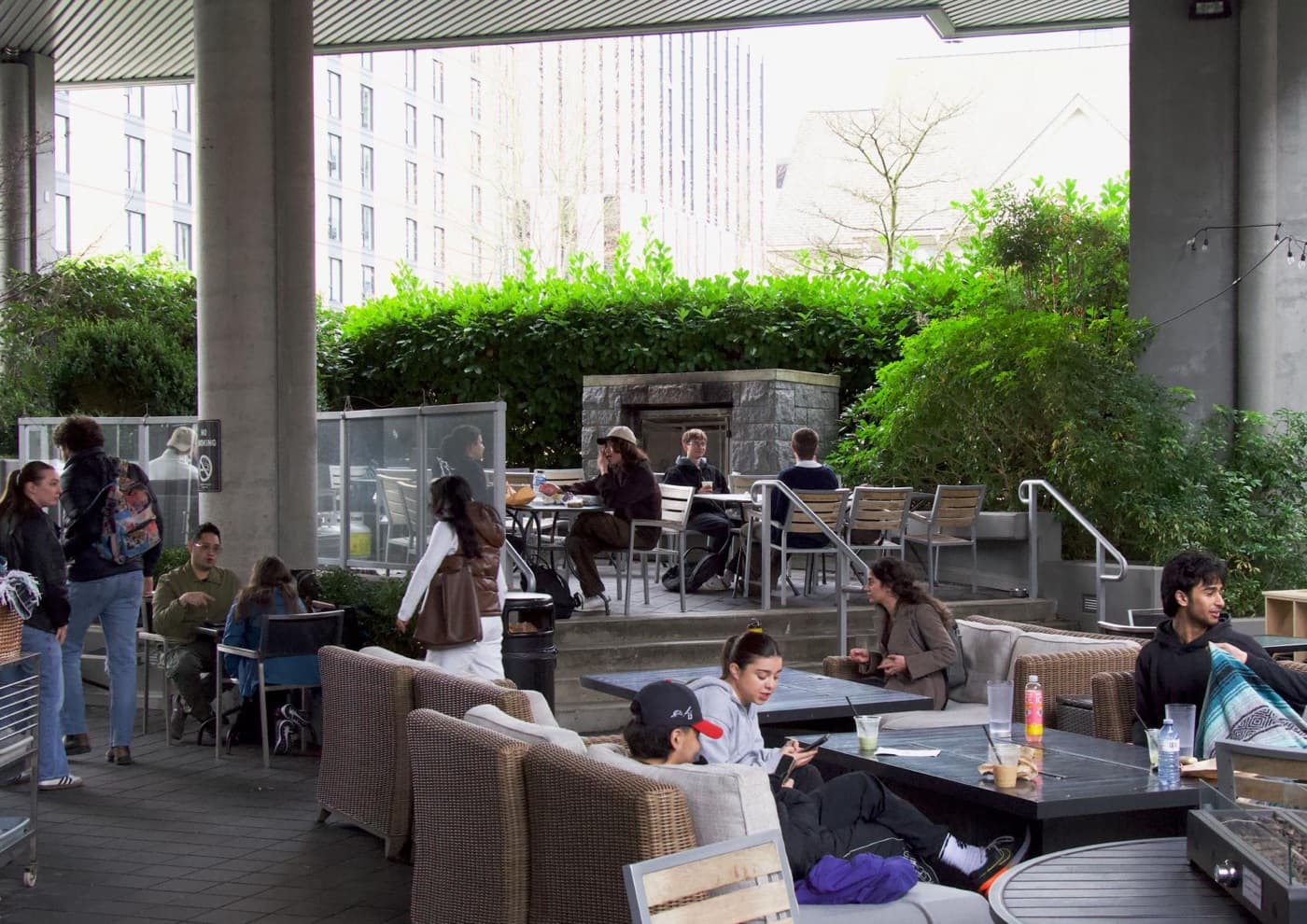 Students filling the covered patio on a spring afternoon