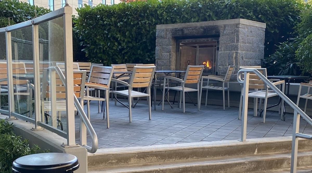 Patio tables around the outdoor stone fireplace